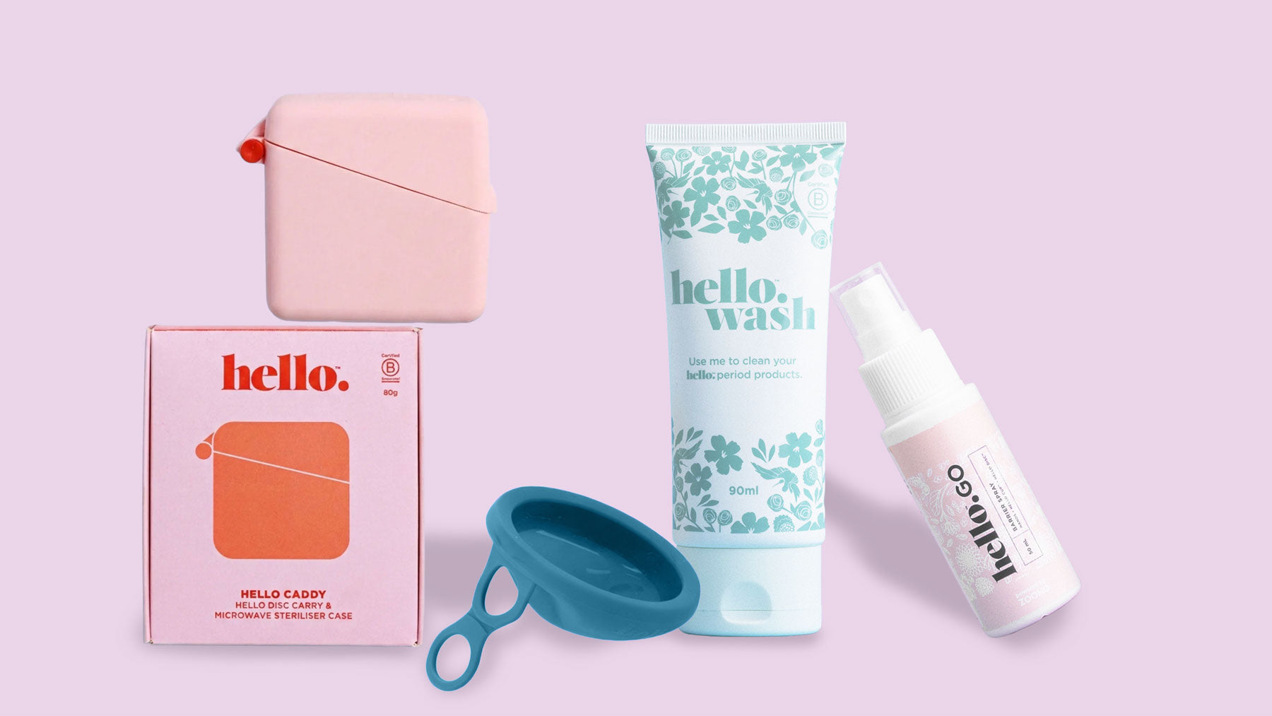Three period care products on a reflective surface: a hello. menstrual disc in a box, a hello. pad reusable pad in a floral box, and a tube of hello. wash cleanser, against a green striped background.