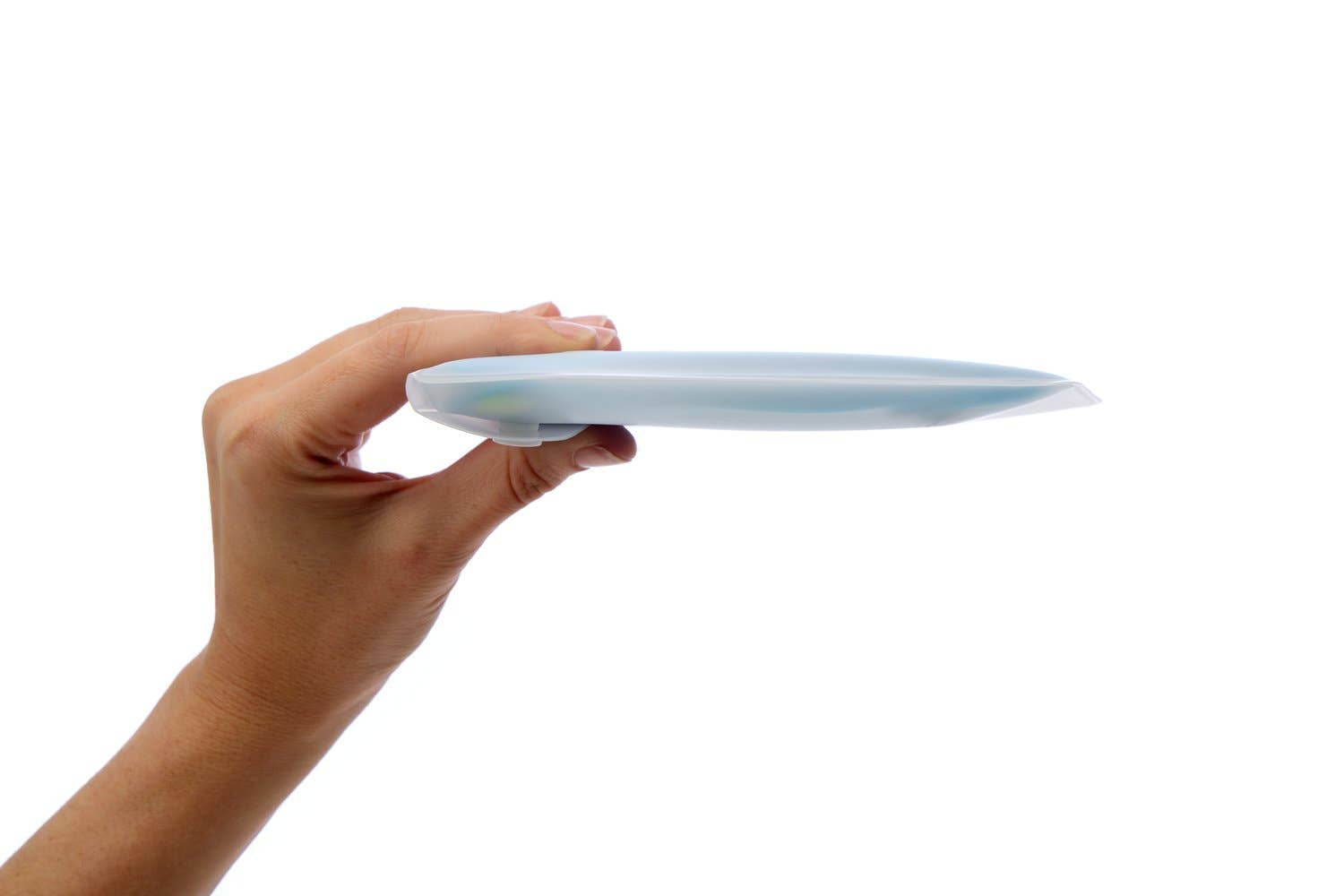 A hand holds the GoPee - Stand to Pee Device sideways against a white background, highlighting its discreet, compact, and portable silicone design.