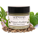 A jar of ProMeno Women's Wild Yam Cream is surrounded by wild yam roots, green leaves, and purple flowers, highlighting its natural ingredients.