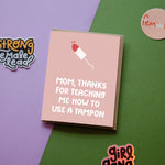 The Thanks for Teaching Me To Use a Tampon Card features hand-lettered text on a pink and green background with a funny illustration, plus nearby stickers that read Strong Female Lead, Feminist, and girl gang.