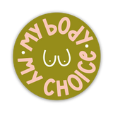 The My Body My Choice Sticker is a round green sticker with pink lettering around a white line drawing of a chest, featuring two dots for nipples—a bold statement supporting women's rights.