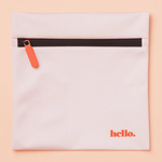 The Hello Wet Bag is a light pink waterproof storage bag featuring an orange zipper pull and "hello." printed in orange in the lower right corner, shown against a soft peach background.