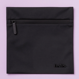The Hello Wet Bag is a black square wet bag featuring a top zipper pocket and "hello." embossed in the lower right corner, shown against a light purple background.