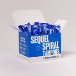 An open blue and white box labeled Sequel™ The Spiral™ Tampons reveals several individually wrapped, helical-grooved tampons. The box contains 32 regular tampons with modern, bold text designed for distraction-free periods.