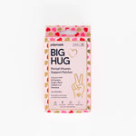 A rectangular box of Big Hug Period Support Vitamin Patches with a pink, red, and gold heart pattern, natural ingredients text, and a hand making a peace sign design for gentle PMS relief.