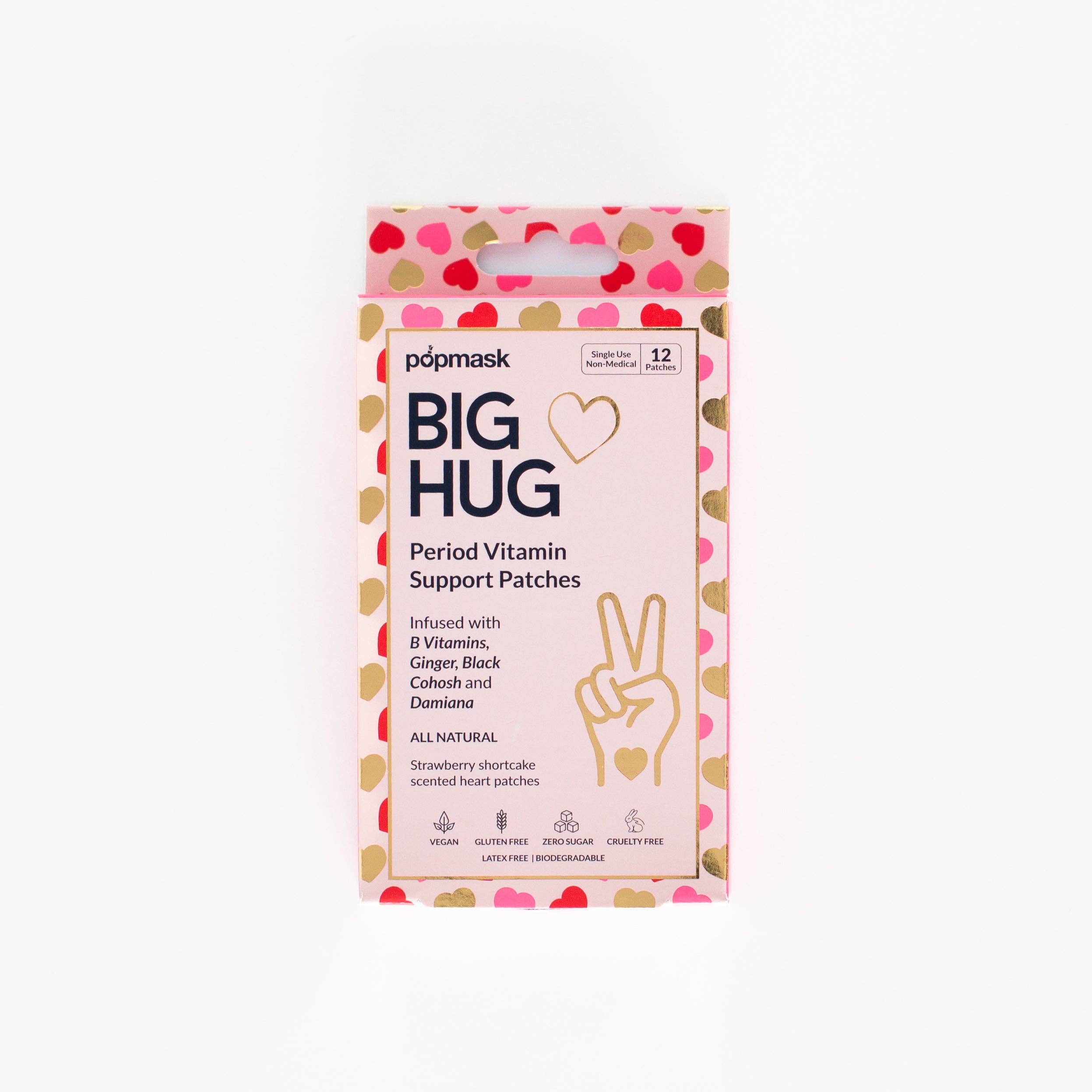 A rectangular box of Big Hug Period Support Vitamin Patches with a pink, red, and gold heart pattern, natural ingredients text, and a hand making a peace sign design for gentle PMS relief.