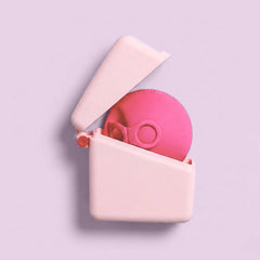 A pink spherical Hello Caddy with goggle-like features rests inside an open, light pink Hello Disc carry case that doubles as a microwave steriliser, set against a pastel lavender background.