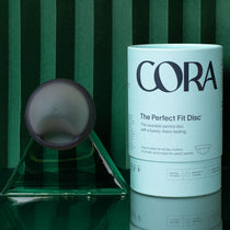 Cora Disc in grey reusable menstrual disc with package