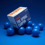 A box of Sequel™ The Spiral™ Tampons, featuring white, blue, and orange text, sits atop several blue oval-shaped objects against a solid blue background. The tampons are designed with helical grooves for distraction-free periods.