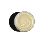 A top-down view of an open glass jar filled with creamy, light beige ProMeno Women's Wild Yam Cream, with the black lid underneath casting a shadow.