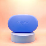 The Fillow Carry Case, a rounded blue case with "Fillow" embossed, sits on a matching pedestal against a peach gradient background, designed as the perfect disc and applicator case for stylish travel storage.