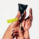 A hand with black nail polish holds a black Flex Cup, a menstrual cup featuring a pull-tab stem for easy removal—making it the only beginner-friendly cup that removes like a tampon.