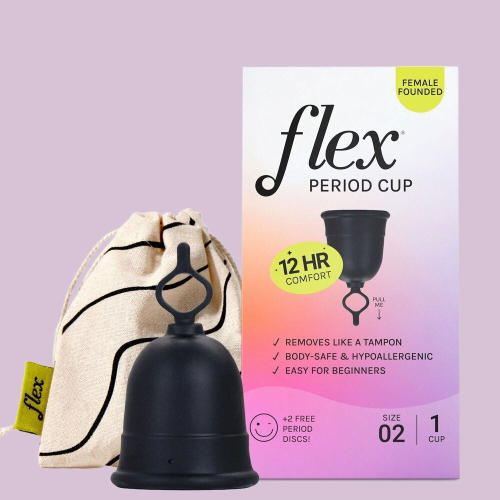 The black Flex Cup menstrual cup is shown before its box, which highlights 12-hour comfort and a beginner-friendly design. Beside the cup is a cream drawstring pouch with a black pattern, all set against a light purple background.