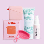 The Hello Disc Clean on-the-go Bundle includes a menstrual disc starter set, period cup cleaning kit, pink storage case, hello.wash tube, spray bottle, collapsible cup, and caddy box—all featured on a light pink background.