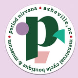 Period Nirvana Souvenir Sticker 4": Round, shiny sticker with geometric shapes, a bold green “p” in the center (Nirvana-inspired), and edge text: “period nirvana • asheville, nc • menstrual cycle boutique & museum.” White background, pale lavender border.