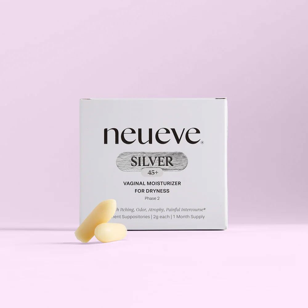 A box of NeuEve Silver 45+ Suppository for vaginal dryness sits on a light pink background, with two cream-colored suppositories in front—specially designed to support menopause and promote vaginal health.