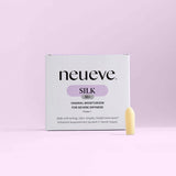 A box of NeuEve Silk 55+ Suppository is displayed against a light purple background, emphasizing vaginal health support, with one suppository standing upright in front of the packaging.