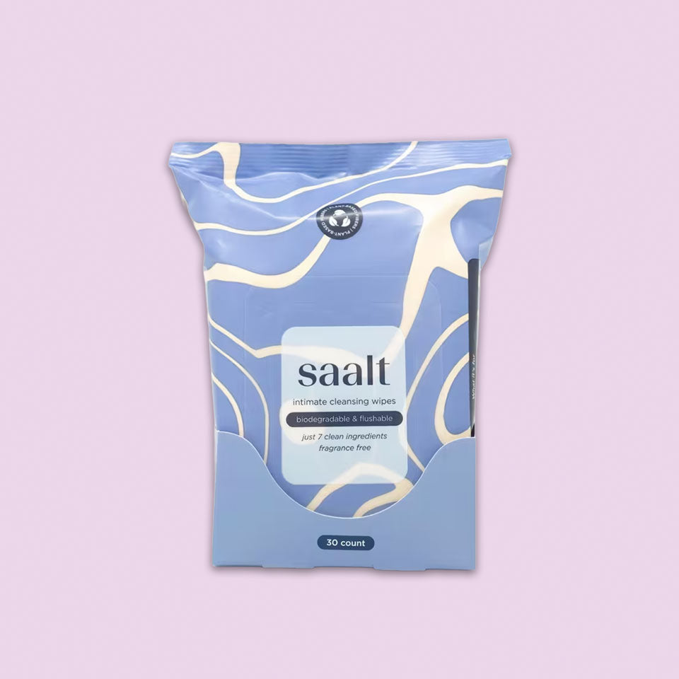 Saalt Intimate Cleansing Wipes, fragrance-free with 30 biodegradable wipes, are shown in a blue and cream abstract package against a light purple background.