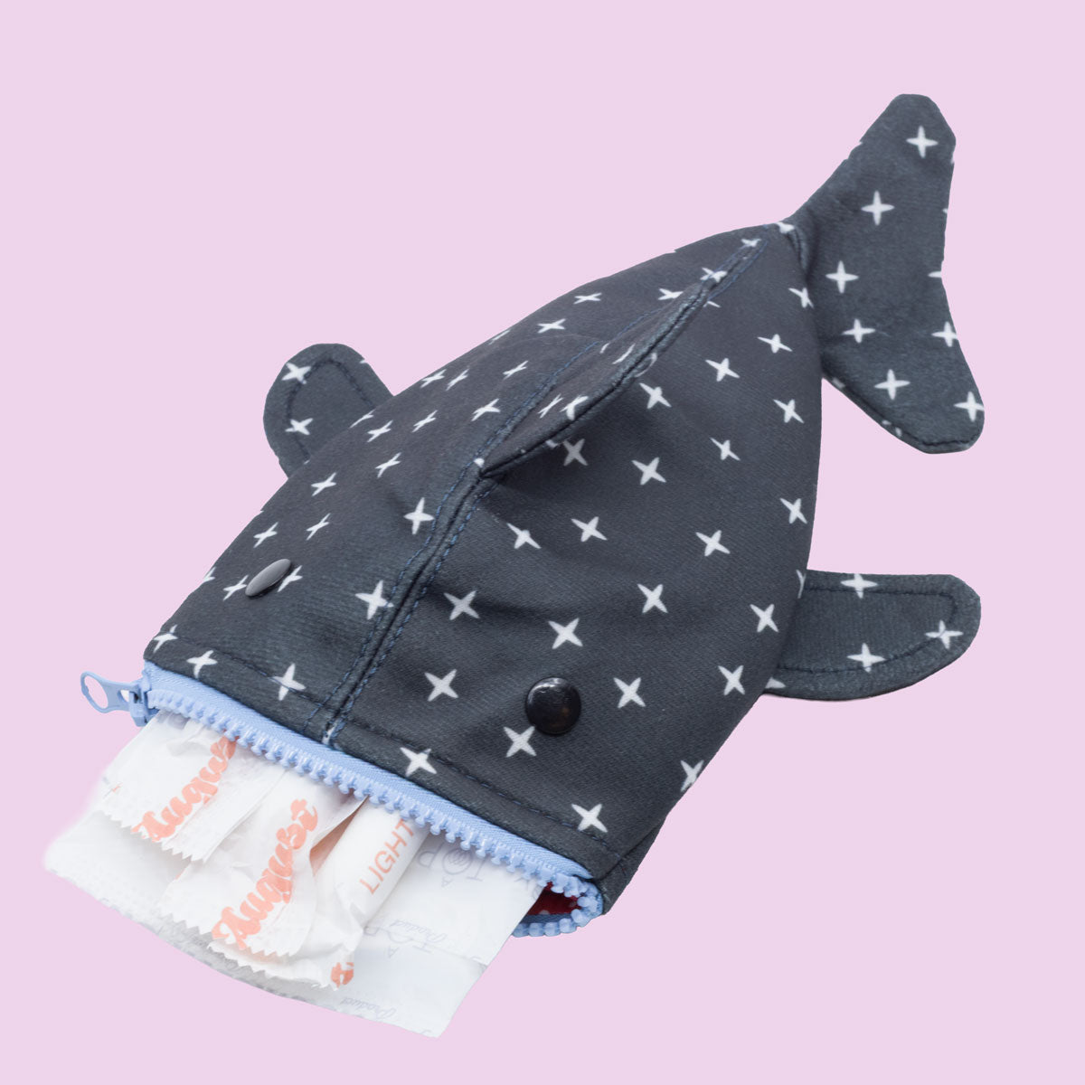 The Shark Week Pouch features a cute whale shark design with a zipper mouth, white X patterns, and space for sanitary pads. Its light pink background makes this adorable period products pouch stand out.