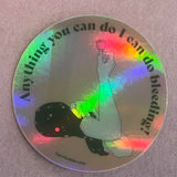 The Rosie Sticker is a round, water-resistant holographic vinyl sticker featuring a raised hand with a menstrual cup and the text "Anything you can do I can do bleeding!" with #perioddrama at the bottom.