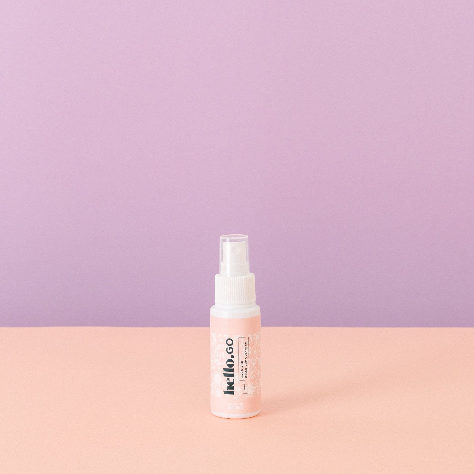 Hello Go spray for cleaning menstrual cups on purple pink background